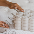 Buy a Pocket Coil Mattress and this is what it is made up of. There are coils in small sleeves that spring when pressed. Image contains two hands pressing on a coil.