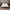 Latex Bed with white mattress featuring bamboo branding, wooden headboard, and nightstands with decor items.