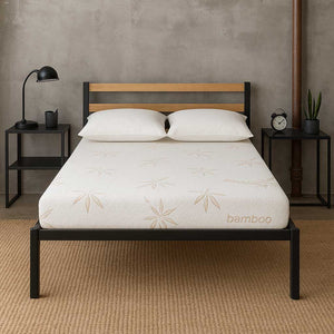 Latex Bed with white mattress featuring bamboo branding, wooden headboard, and nightstands with decor items.
