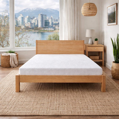 Low Cost Latex Mattress on Bed Frame with Vancouver skyline in back. 